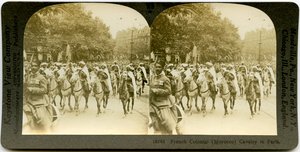Horizontal, sepia, stereocard showing uniformed men on horseback marching in a parade. Keystone Stereograph number 18743. The title reads by Keystone View Company